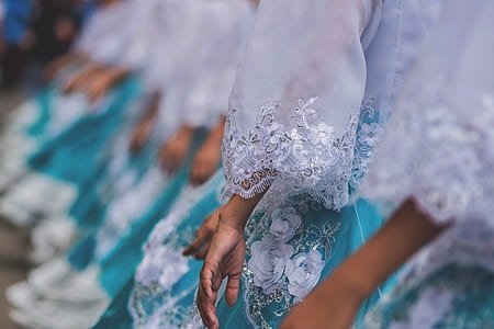 group of people wearing teal-and-white floral dress thumbnail