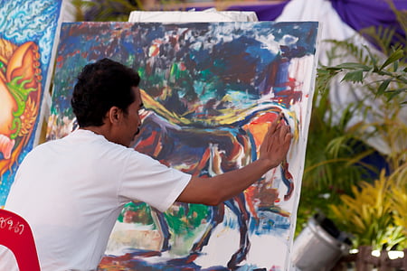 man painting while sitting during daytime thumbnail