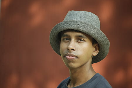 Selective Focus Photography of Man Wearing Gray Fedora Hat and Gray Crew-neck Shirt thumbnail