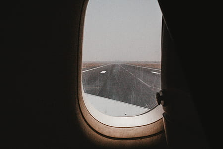 airliner window viewing runway during daytime thumbnail