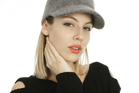 woman wearing black cold-shoulder knit sweatshirt and grey suede cap thumbnail