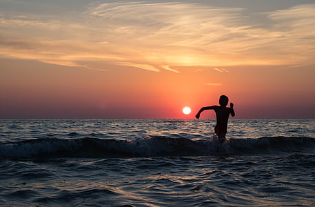 silhouette of person on body of water thumbnail