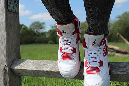 person wearing white-and-red Air Jordan Flight shoes thumbnail