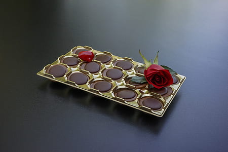 chocolate case with red rose flower on black surface thumbnail