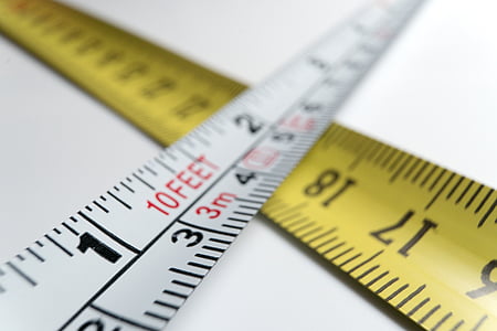 closeup photo of two white and yellow tape measures thumbnail