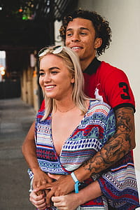 Woman Standing Infront on Man Hands over Arm thumbnail