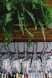 A big bunch of wine glasses hanging from a holder thumbnail