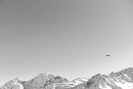 paragliding over tundra mountain thumbnail