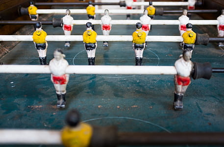 green and white foosball table in tilt shift photography thumbnail