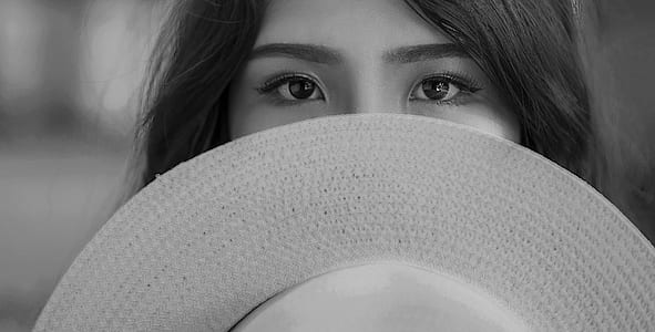 Grayscale Photography of Woman Covering Her Face With Sun Hat thumbnail