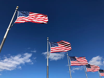 five U.S. flags hanged on pole under cloudy sky thumbnail