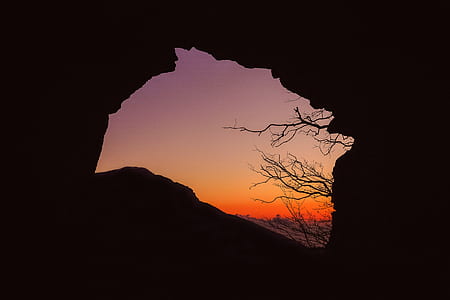 silhouette photography of cave during sunset thumbnail