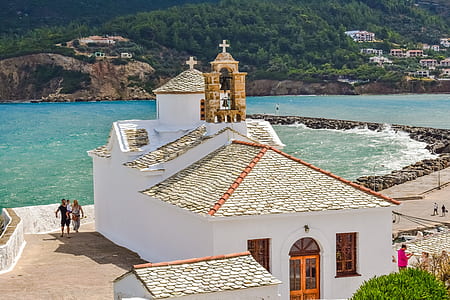 white and brown concrete church near body of water thumbnail