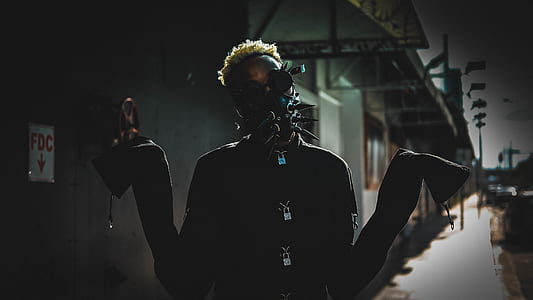 man wearing mask standing on street thumbnail