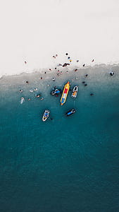 aerial view of boats with group of people on body of water thumbnail