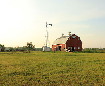 red barn in midst of green field thumbnail