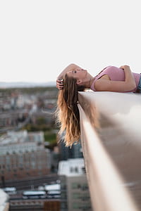 woman lying on white concrete surface thumbnail