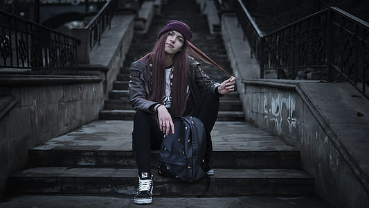 woman in jacket sitting on staircase thumbnail