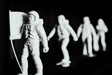 selective focus photography of four inline astronaut figurines thumbnail