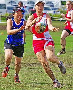 two women running on grass field thumbnail