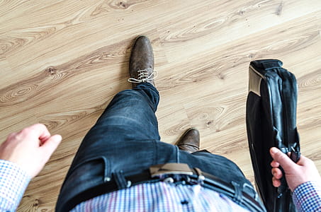 Man Walking Holding Leather Bag thumbnail