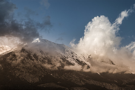white and grey mountain with white snow and clouds under the blue sky during daytime thumbnail