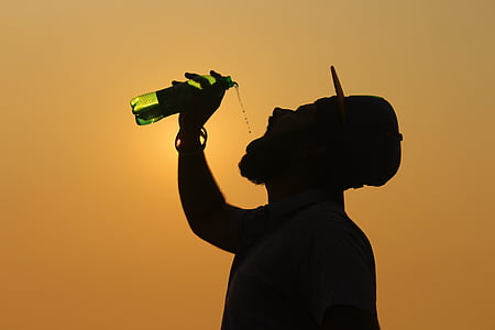 silhouette of man drinking during sunset thumbnail