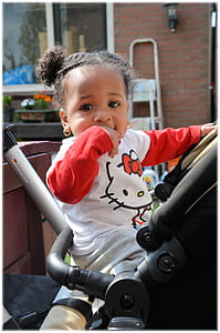 girl on stroller near house thumbnail