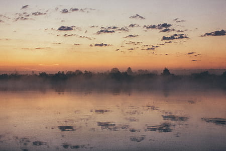 photo of body of water during sunset thumbnail