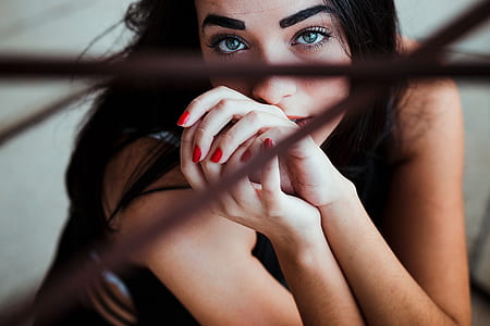 woman sitting down near fence thumbnail