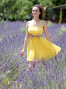 woman in dress standing on flower field thumbnail