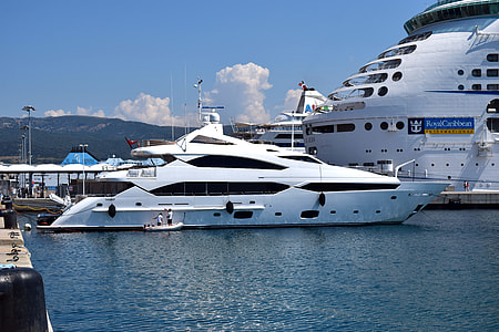 white yacht near cruise ship docked on seaport thumbnail