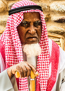 man holding walking cane near brown wall thumbnail