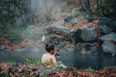 topless man swimming on lake thumbnail