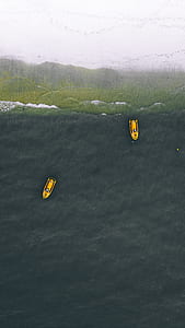 aerial view photography of two boats on body of water near seashore during daytime thumbnail
