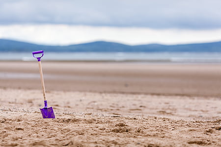 photo of purple shovel on sand thumbnail