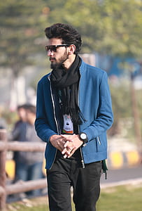 man wearing black scarf and blue zip-up jacket thumbnail