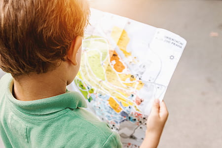 boy wearing green polo shirt holding map illustration thumbnail