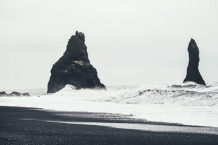 gray scale photography of sea shore with high waves thumbnail