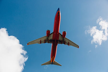 low angle photography of red and white airplane thumbnail