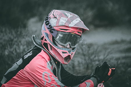 man wearing red and black motocross helmet and jacket thumbnail