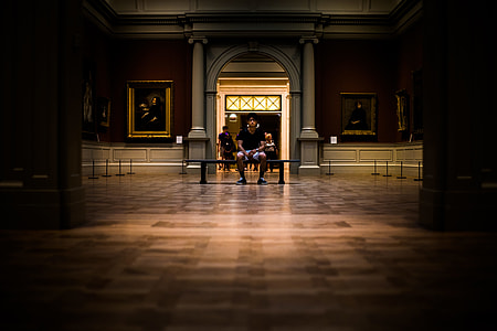 man sitting on black wooden bench thumbnail