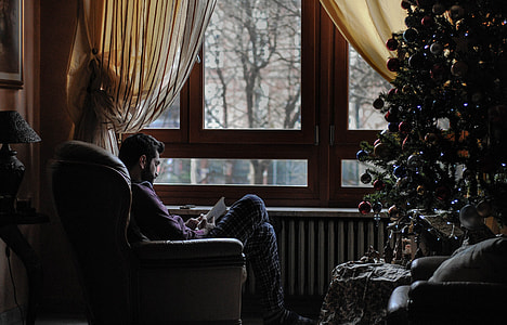 man sitting on chair while reading thumbnail