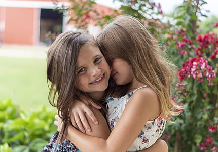 Close-Up Photo of Two Little Girls Hugging Each Other thumbnail