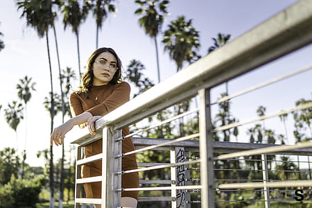 woman standing on corner terrace leaning on rail thumbnail