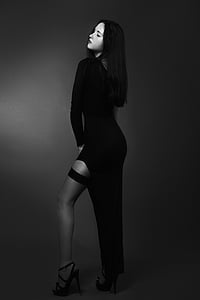 woman posing wears black long-sleeved dress thumbnail