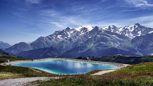 snowy mountain near body of water during daytime thumbnail
