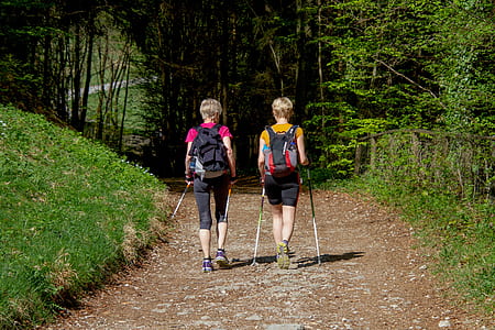 two persons walking along the pathway during daytime thumbnail