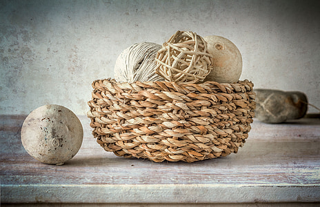 basket of ball ornaments inside wicker brown basket thumbnail