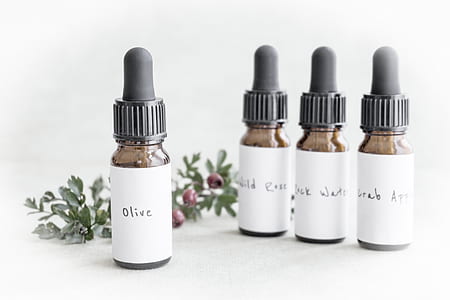 four white labeled droplet bottles on white surface thumbnail